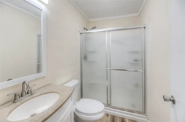 a bathroom with a granite countertop sink toilet and shower