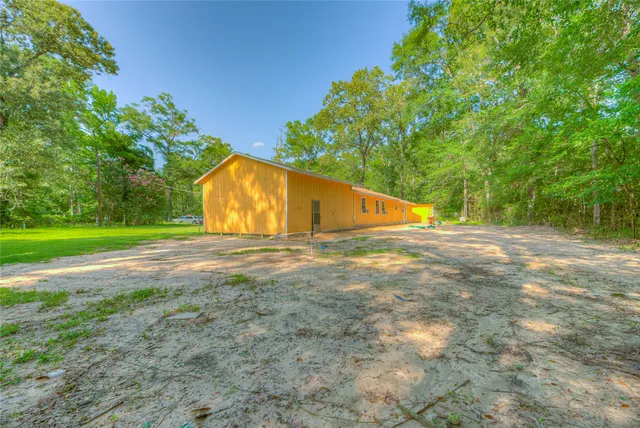 a view of backyard with large trees