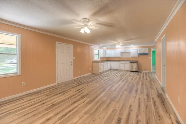 a view of empty room with wooden floor