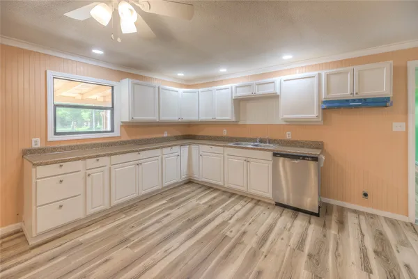 a kitchen with granite countertop white cabinets and white appliances