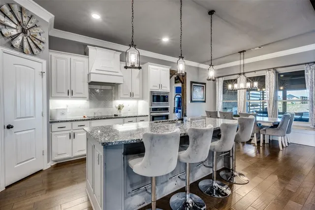 a kitchen with stainless steel appliances granite countertop a stove and a refrigerator