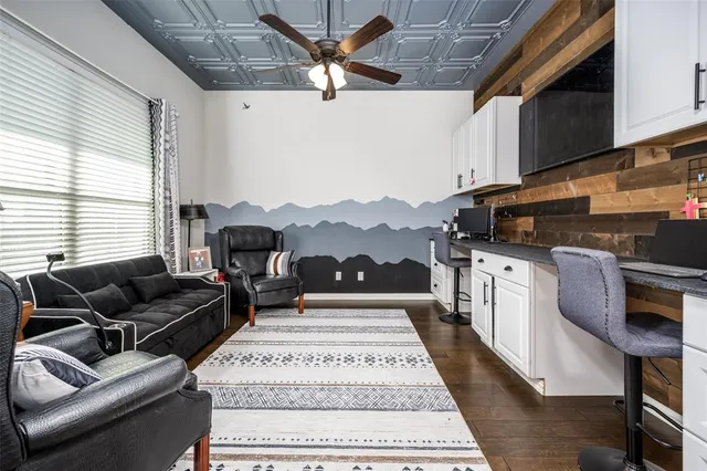 a living room with furniture a rug and a fireplace