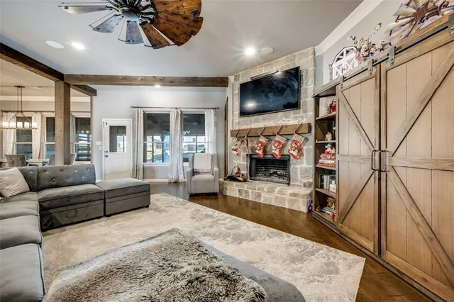 a living room with furniture a flat screen tv and a fireplace