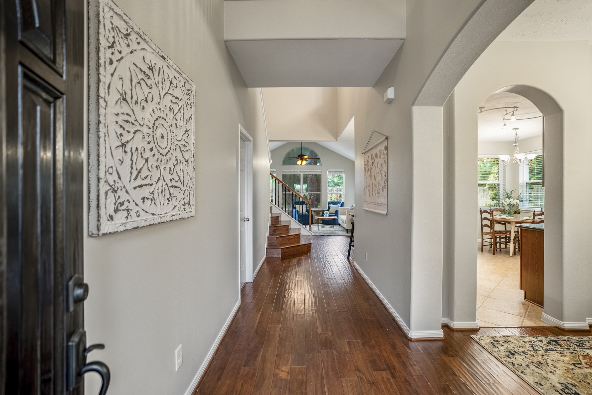 6311 Sparrows Glen Lane Spring, TX 77379 - Photo 5 of 50 Stepping through the front door, the 2-story foyer opens with formal dining to the right, the staircase just ahead, and the main living spaces continuing beyond.