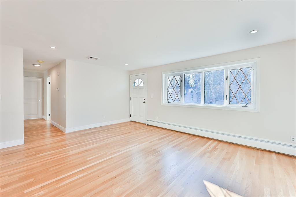 8 Dianthus Road Holbrook, MA 02343 - Photo 16 of 20 a view of an empty room with wooden floor and a window