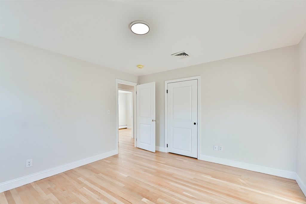 8 Dianthus Road Holbrook, MA 02343 - Photo 17 of 20 a view of an empty room with wooden floor