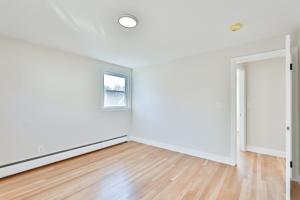 8 Dianthus Road Holbrook, MA 02343 - Photo 18 of 20 an empty room with wooden floor and windows