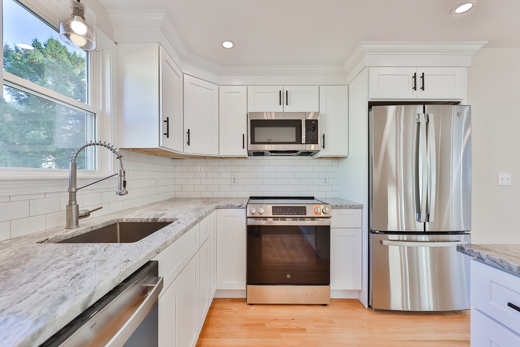 8 Dianthus Road Holbrook, MA 02343 - Photo 3 of 20 a kitchen with granite countertop a refrigerator stove and sink