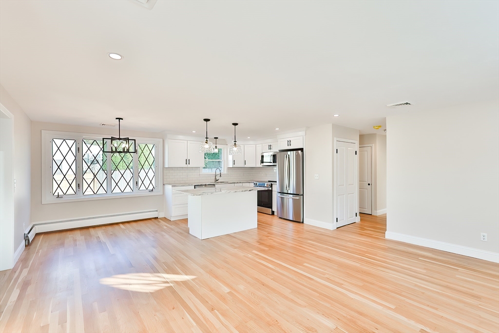 8 Dianthus Road Holbrook, MA 02343 - Photo 4 of 20 a view of a kitchen with kitchen island wooden floors and stainless steel appliances