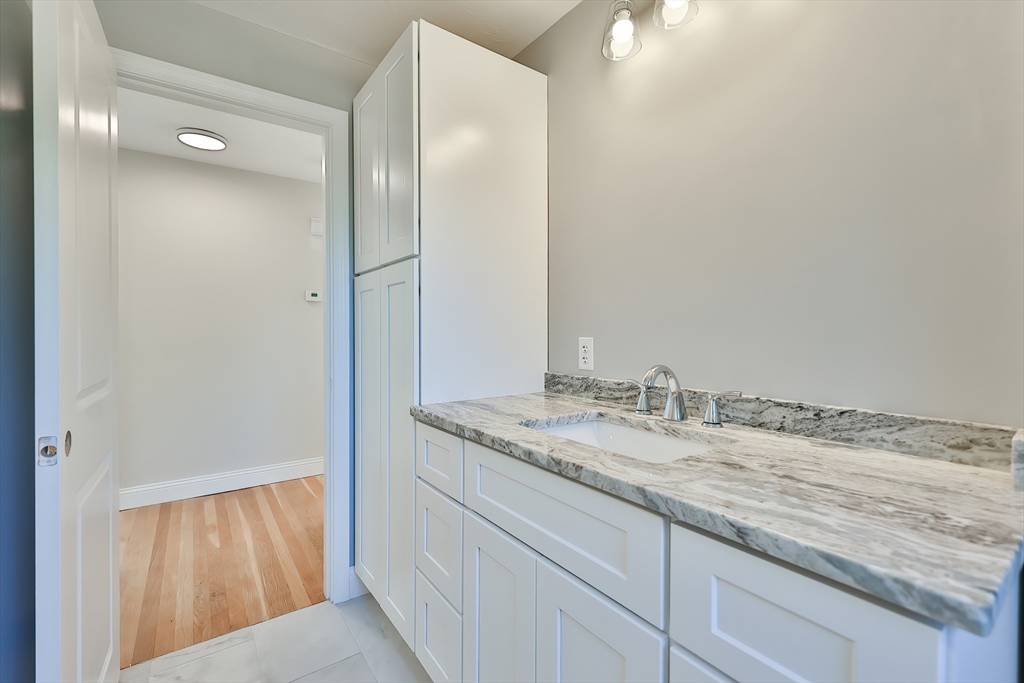 8 Dianthus Road Holbrook, MA 02343 - Photo 6 of 20 a bathroom with a granite countertop sink and a mirror