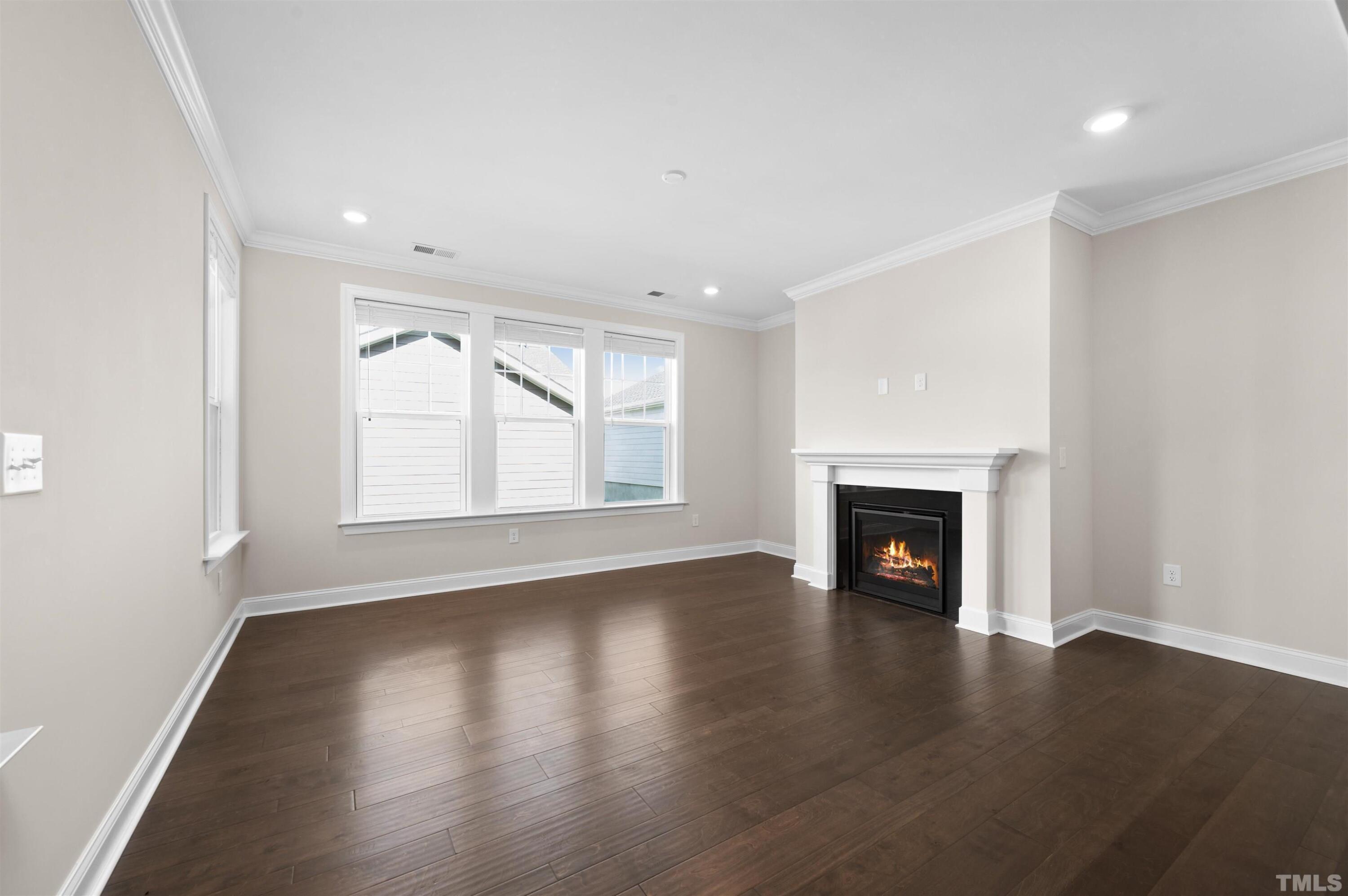 2917 Early Planting Avenue Apex, NC 27502 - Photo 12 of 41 a view of an empty room with wooden floor and a window