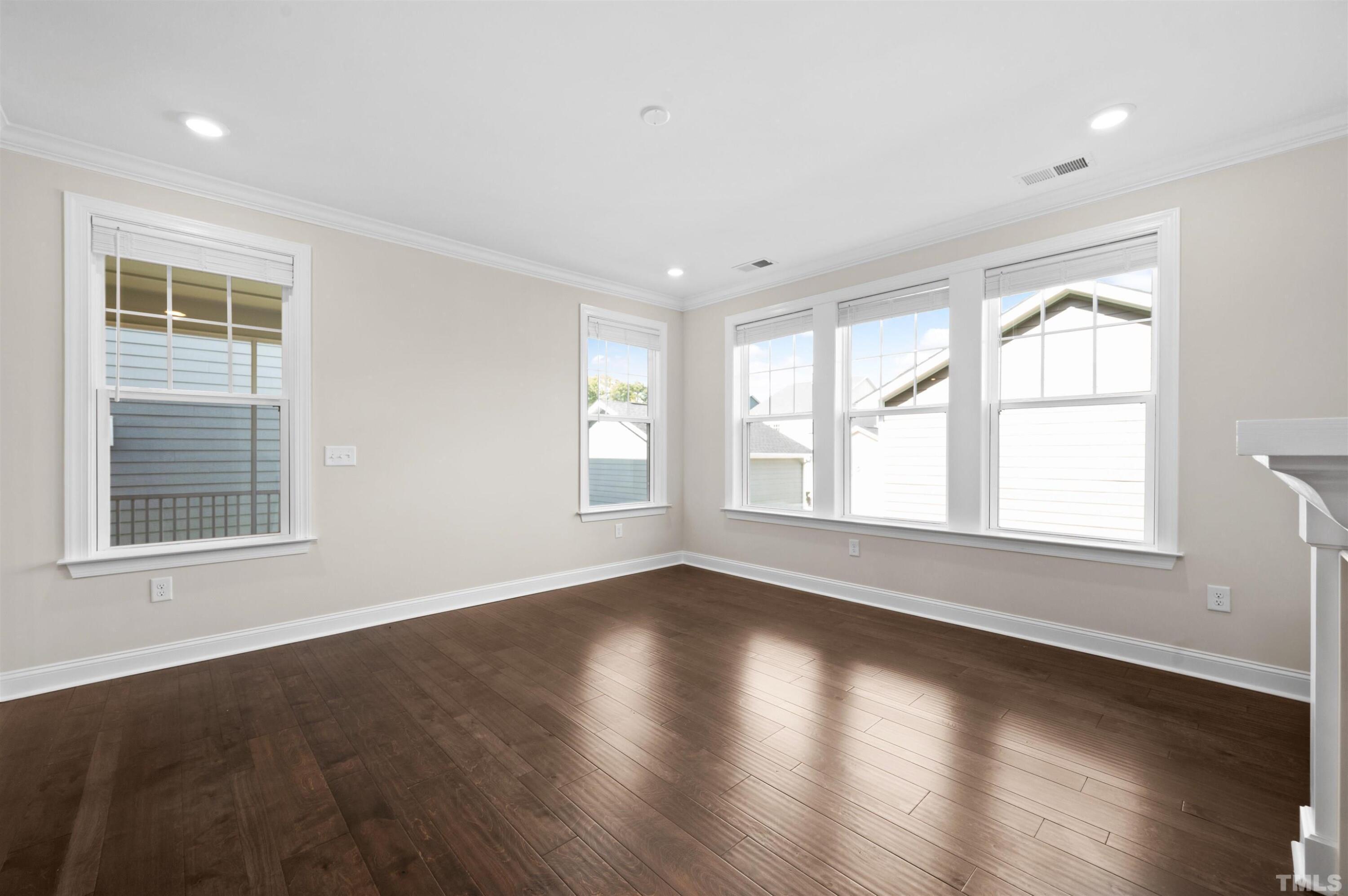 2917 Early Planting Avenue Apex, NC 27502 - Photo 13 of 41 a view of an empty room with wooden floor and a window