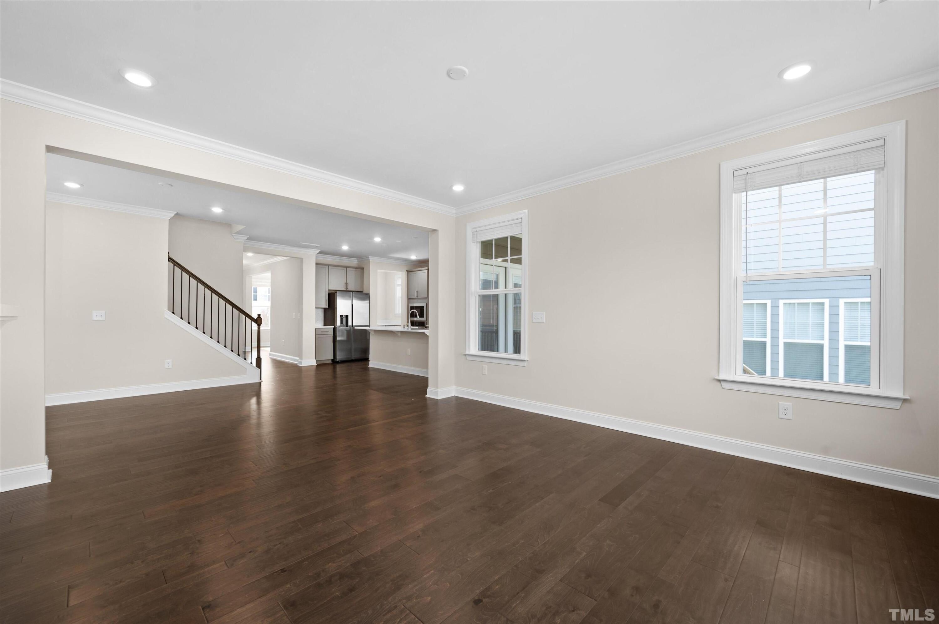 2917 Early Planting Avenue Apex, NC 27502 - Photo 14 of 41 a view of an empty room with wooden floor and a window