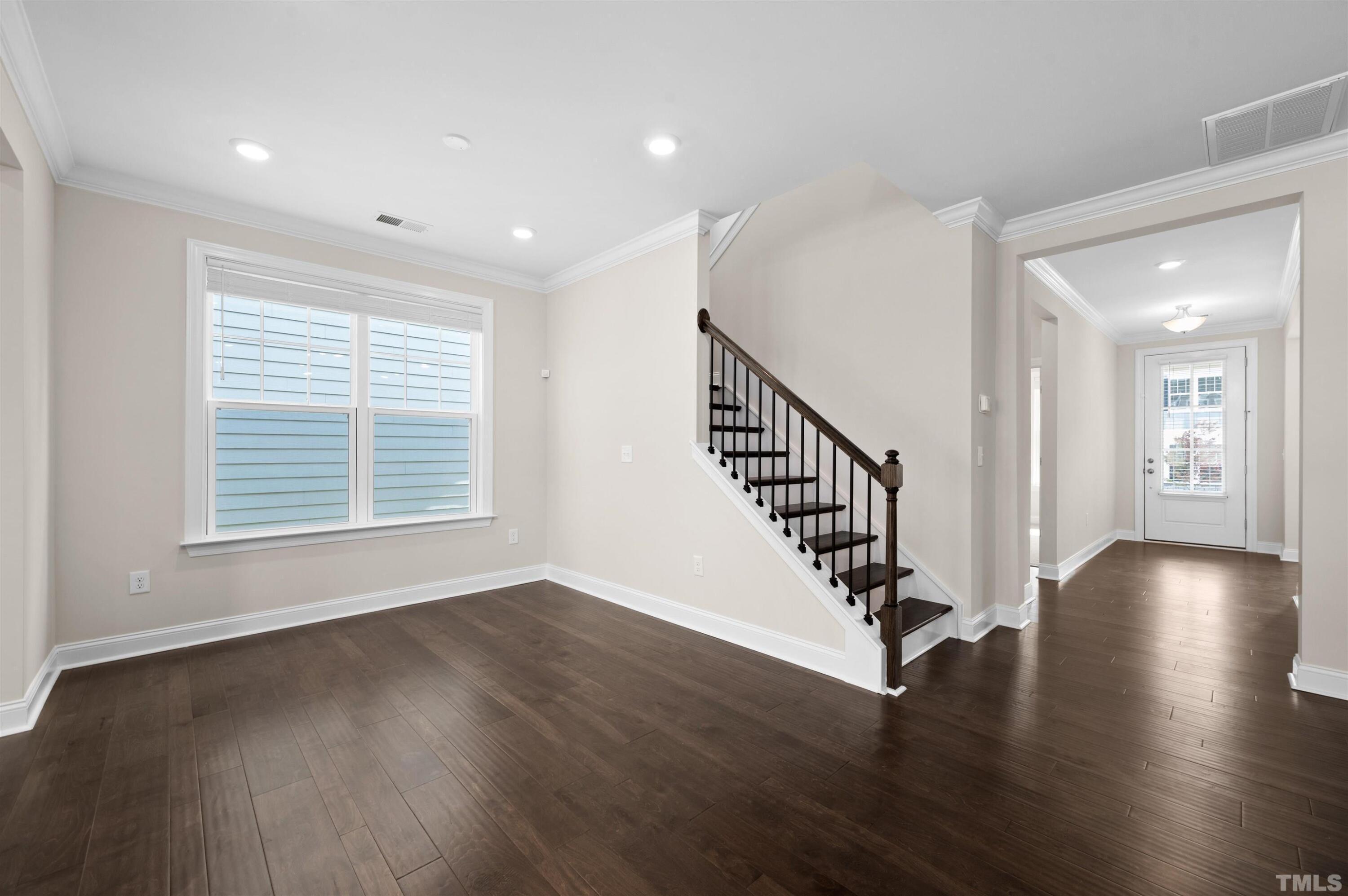 2917 Early Planting Avenue Apex, NC 27502 - Photo 16 of 41 a view of entryway with wooden floor and stairs