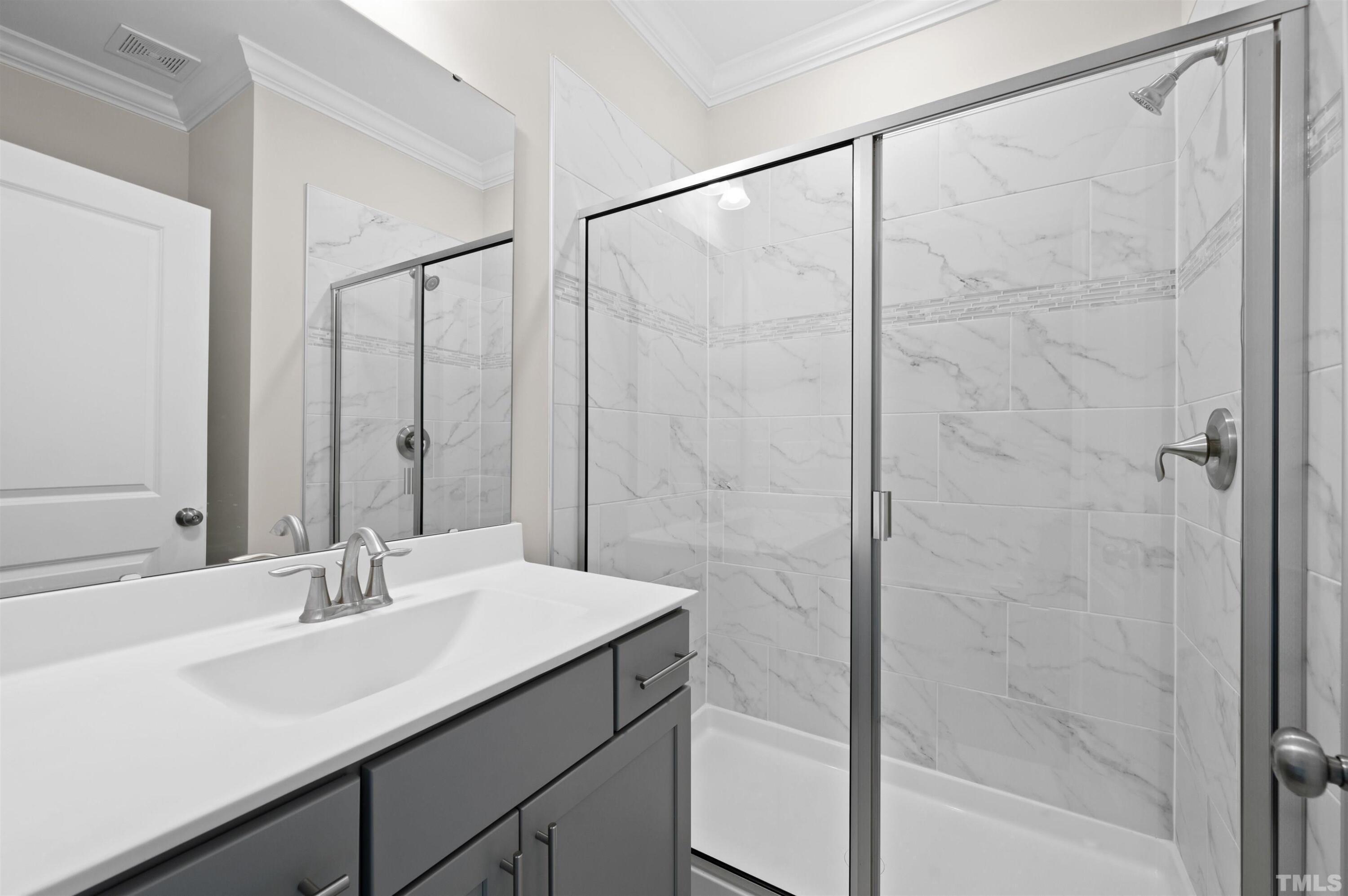 2917 Early Planting Avenue Apex, NC 27502 - Photo 18 of 41 a bathroom with a sink and a mirror