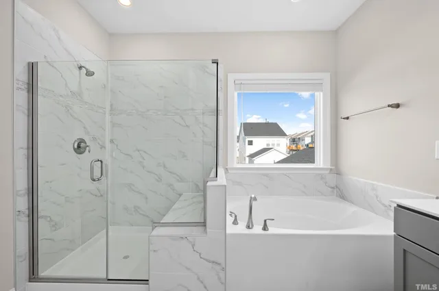 a spacious bathroom with a bathtub sink and mirror