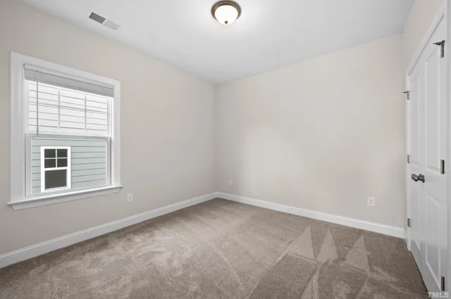 a view of an empty room and closet area