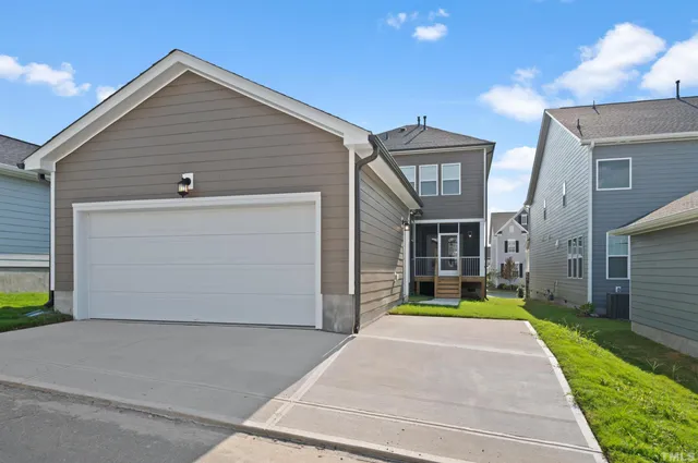 a view of a house with a backyard