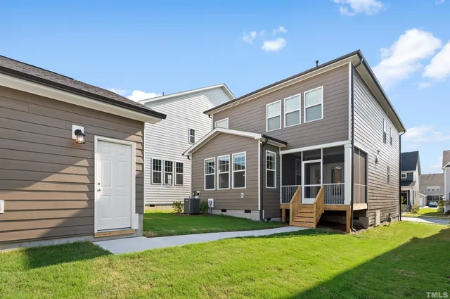 a view of a house with pool and chairs