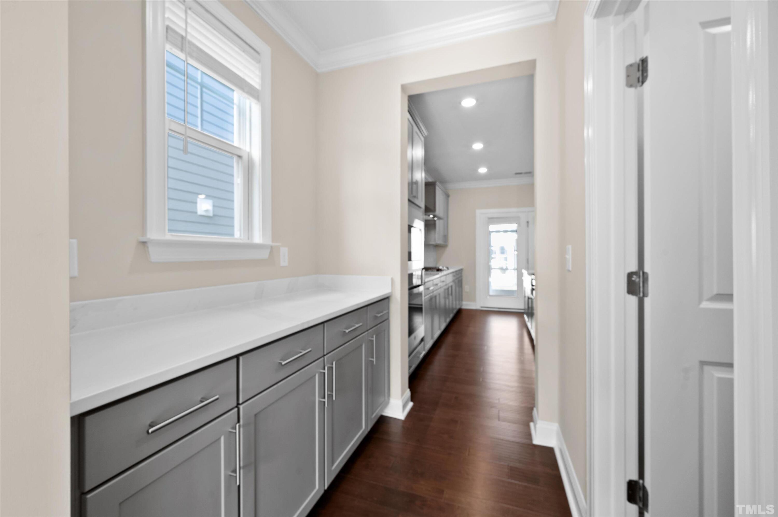 2917 Early Planting Avenue Apex, NC 27502 - Photo 4 of 41 a view of a hallway with wooden floor and staircase