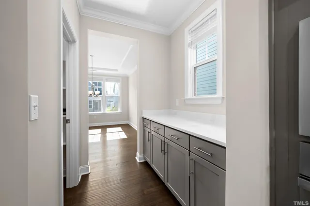 a kitchen with stainless steel appliances granite countertop a sink and cabinets with wooden floor