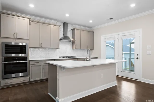 a kitchen with a refrigerator and white cabinets