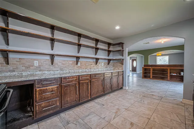 a kitchen with stainless steel appliances granite countertop a sink and cabinets