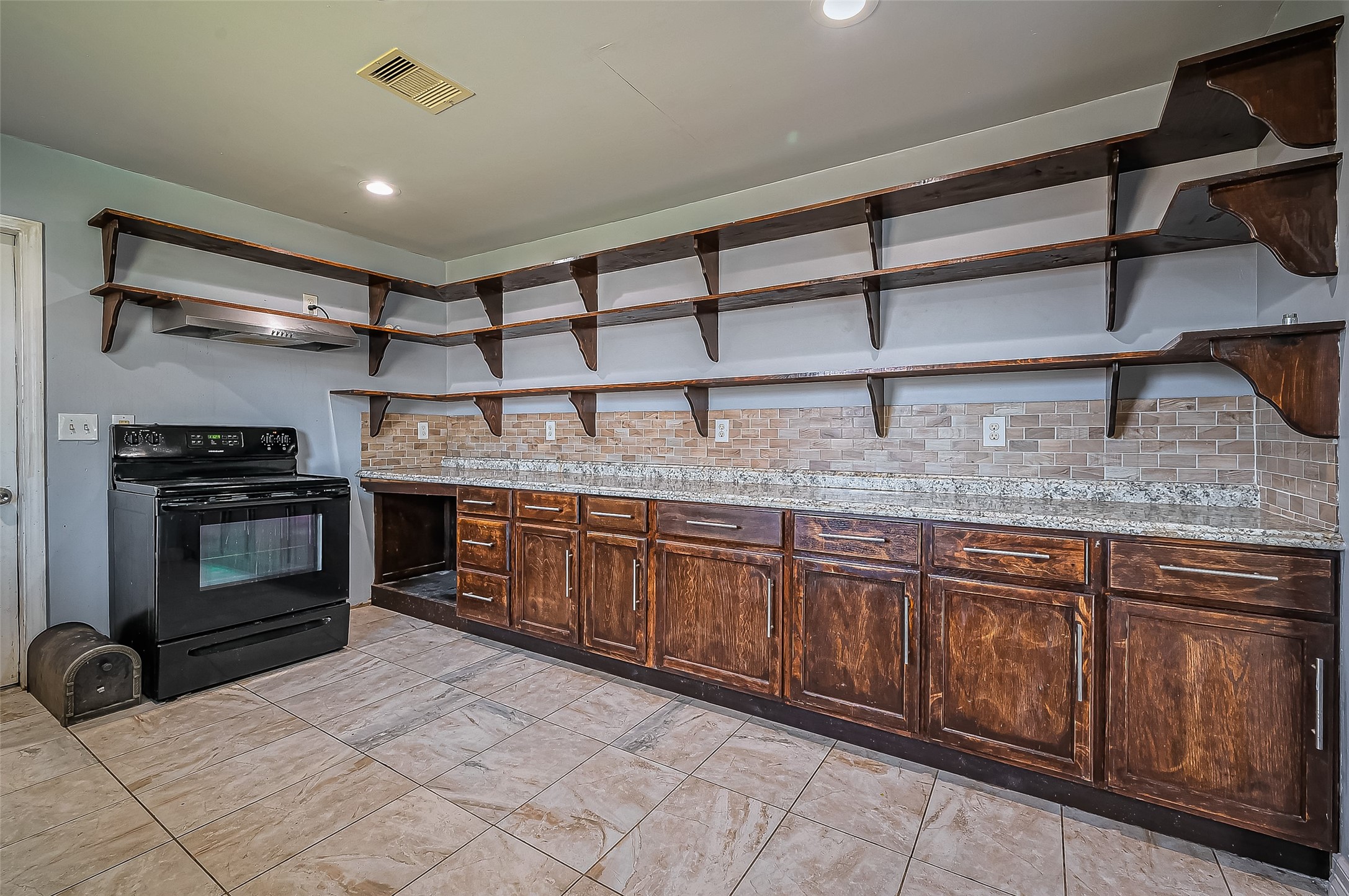 710 East Sycamore Street Fresno, TX 77545 - Photo 13 of 32 a kitchen with stainless steel appliances granite countertop a stove and a sink
