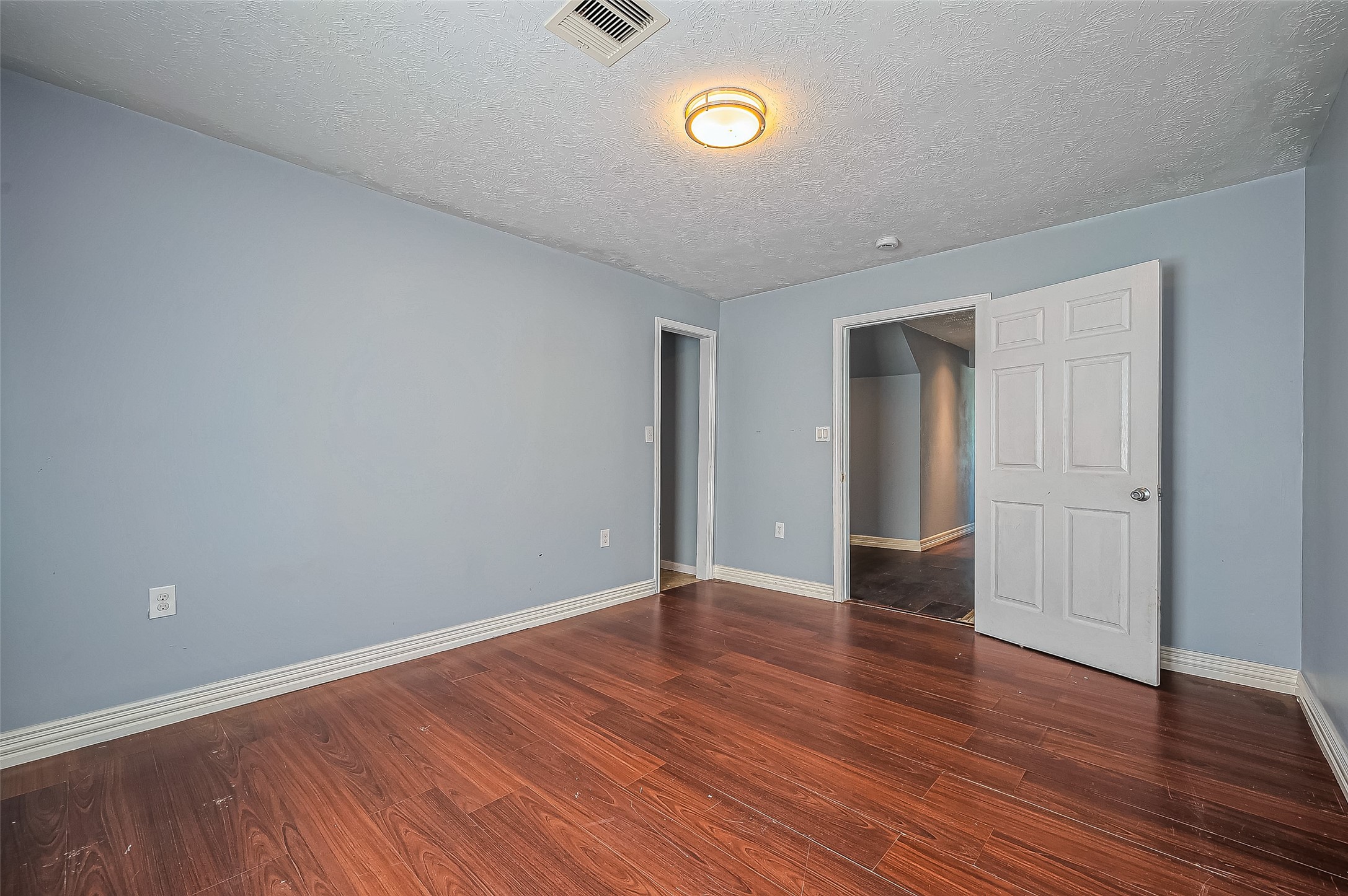 710 East Sycamore Street Fresno, TX 77545 - Photo 16 of 32 a view of an empty room with wooden floor
