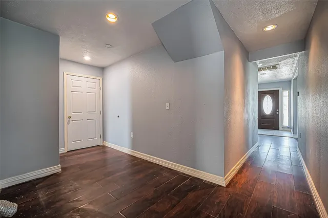 wooden floor in a hall with an empty room