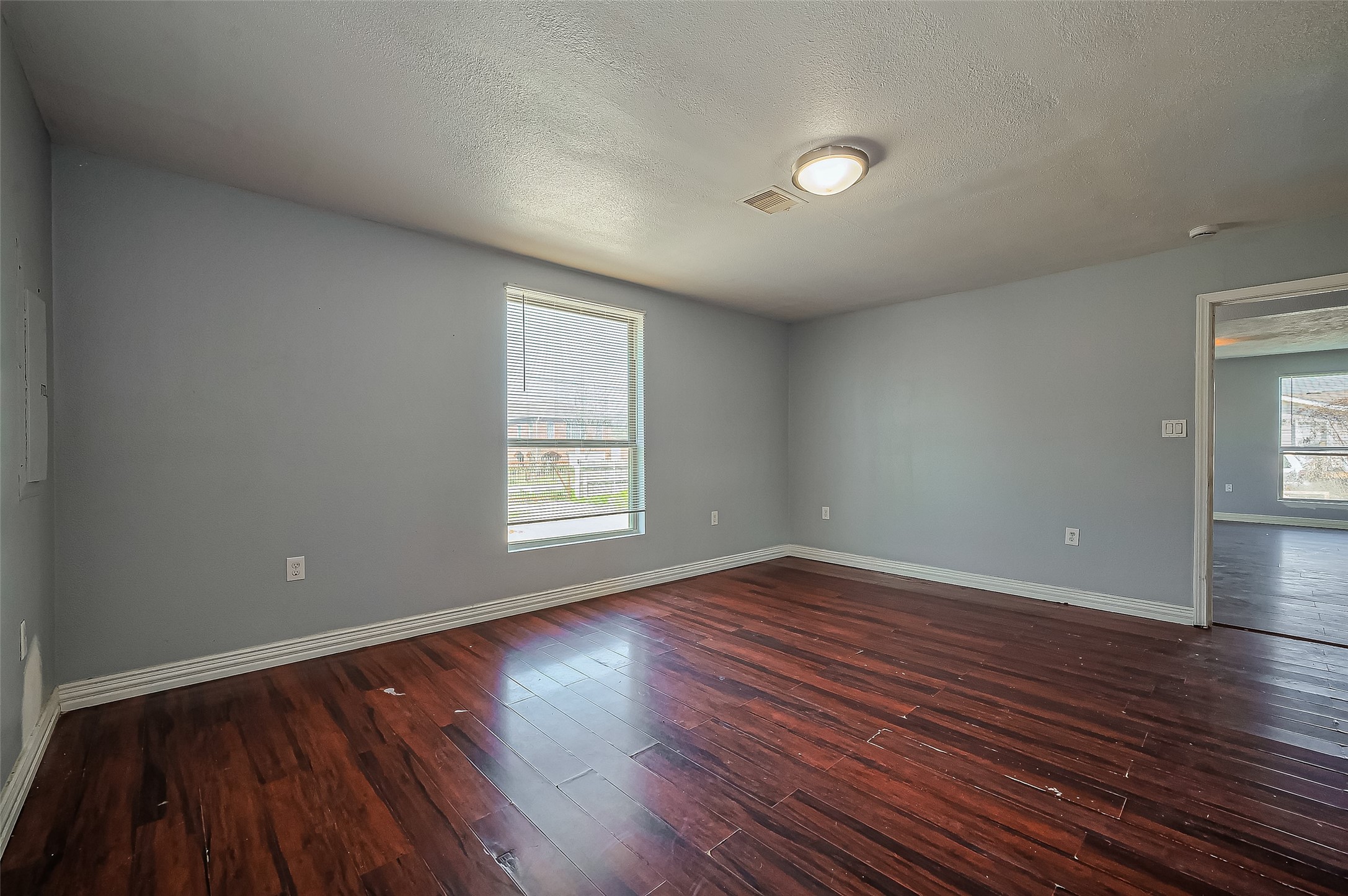 710 East Sycamore Street Fresno, TX 77545 - Photo 22 of 32 an empty room with wooden floor and windows
