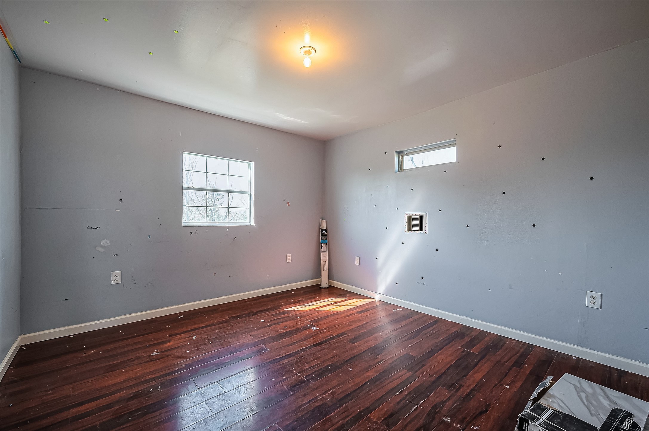 710 East Sycamore Street Fresno, TX 77545 - Photo 28 of 32 an empty room with wooden floor and windows