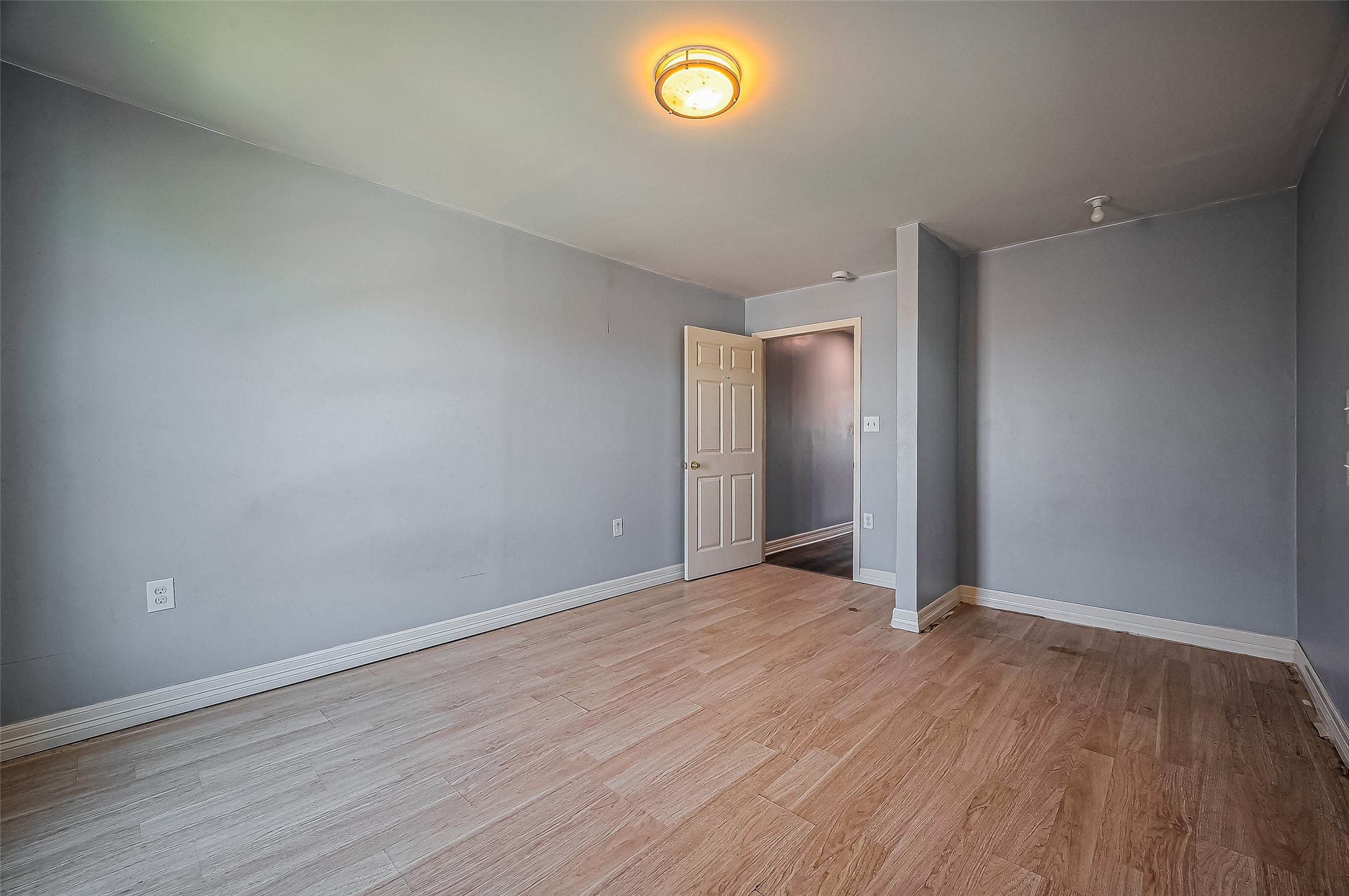 710 East Sycamore Street Fresno, TX 77545 - Photo 29 of 32 a view of an empty room with wooden floor and a window