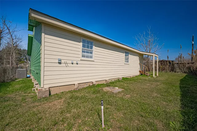 a view of a backyard with plants and a backyard