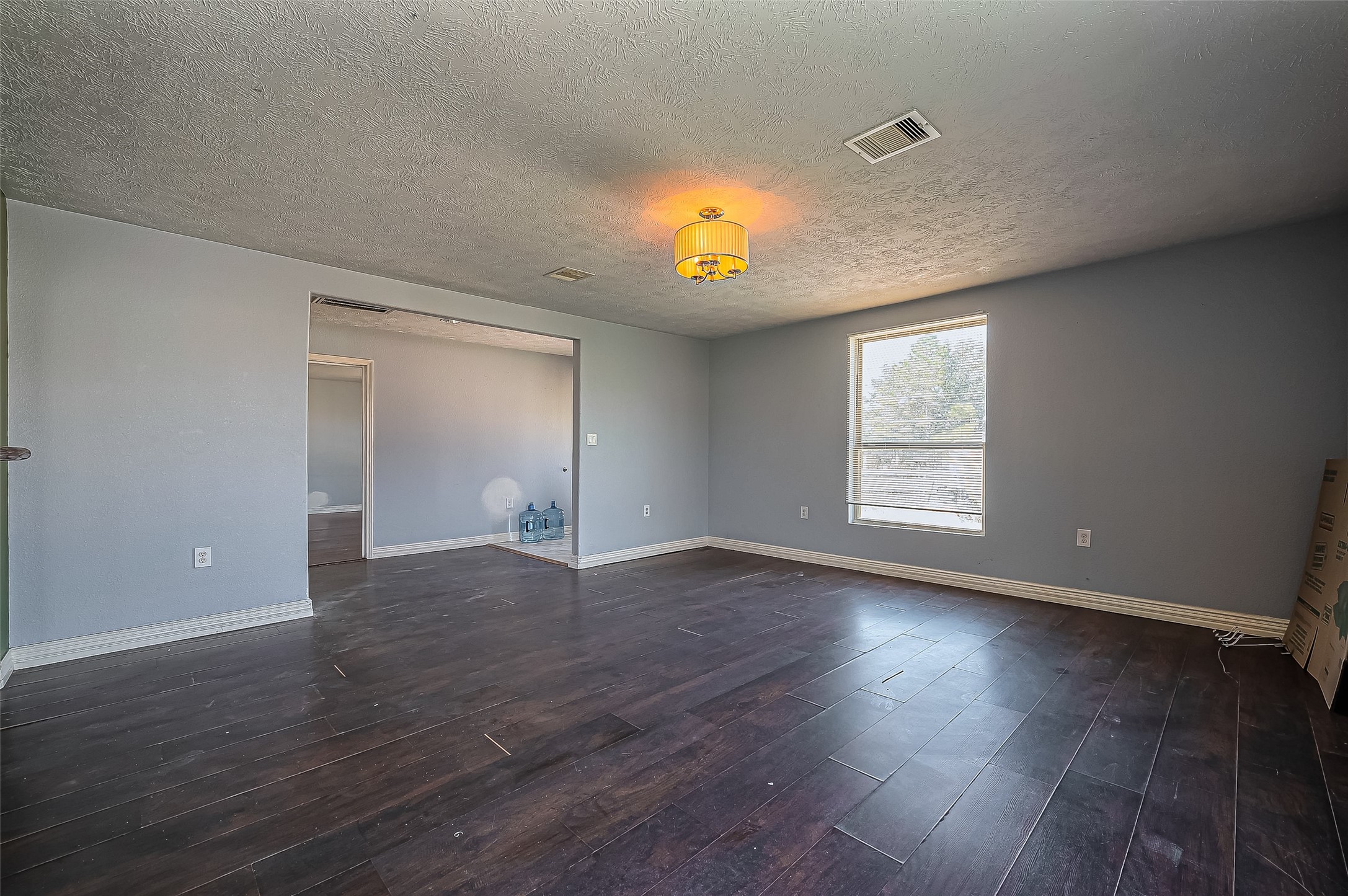 710 East Sycamore Street Fresno, TX 77545 - Photo 5 of 32 an empty room with wooden floor and windows