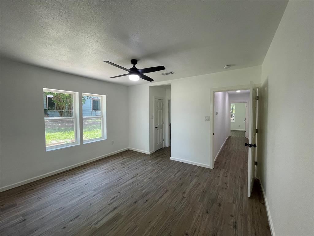 607 East Monterey Street Denison, TX 75021 - Photo 13 of 34 a view of livingroom with hardwood floor and window