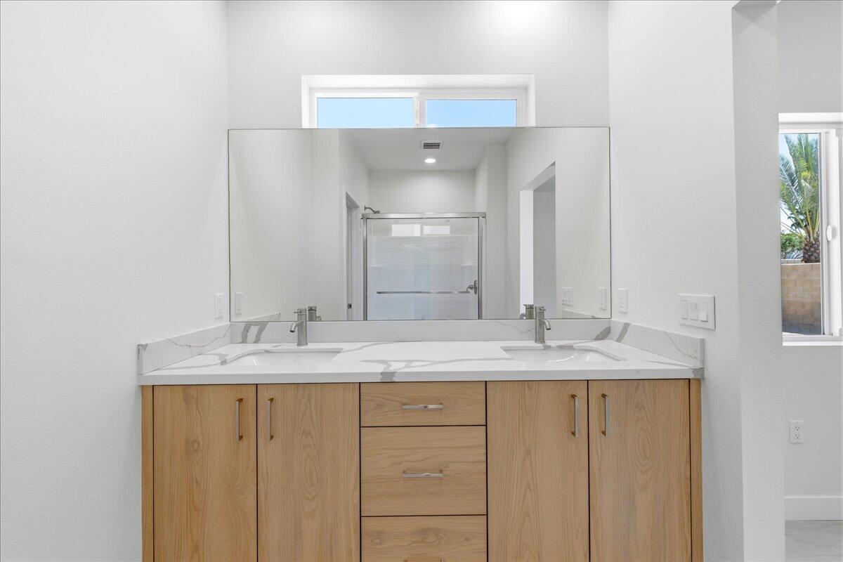 68160 Modalo Road Cathedral City, CA 92234 - Photo 19 of 57 a bathroom with a granite countertop sink and a mirror