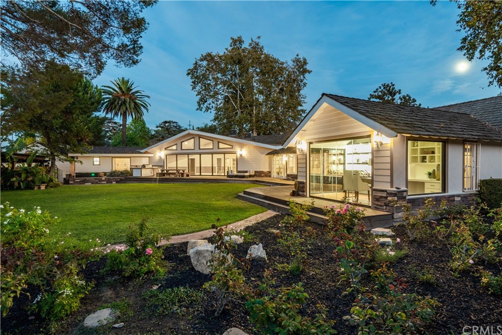 a view of a house with a big yard and potted plants