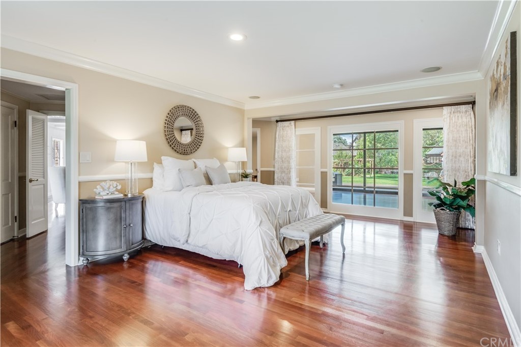 4255 Chestnut Avenue Long Beach, CA 90807 - Photo 26 of 48 a bedroom with a large bed and a wooden floor