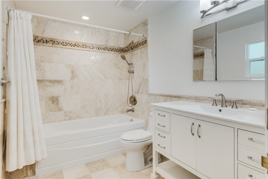 4255 Chestnut Avenue Long Beach, CA 90807 - Photo 32 of 48 a bathroom with a granite countertop sink a toilet and shower