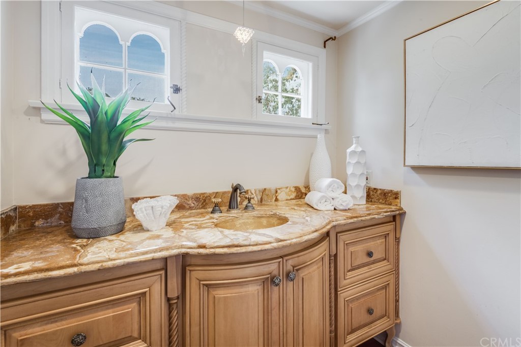 4255 Chestnut Avenue Long Beach, CA 90807 - Photo 33 of 48 a bathroom with a granite countertop sink a mirror and vanity