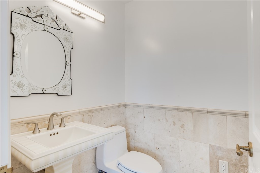 4255 Chestnut Avenue Long Beach, CA 90807 - Photo 34 of 48 a bathroom with a toilet sink and mirror