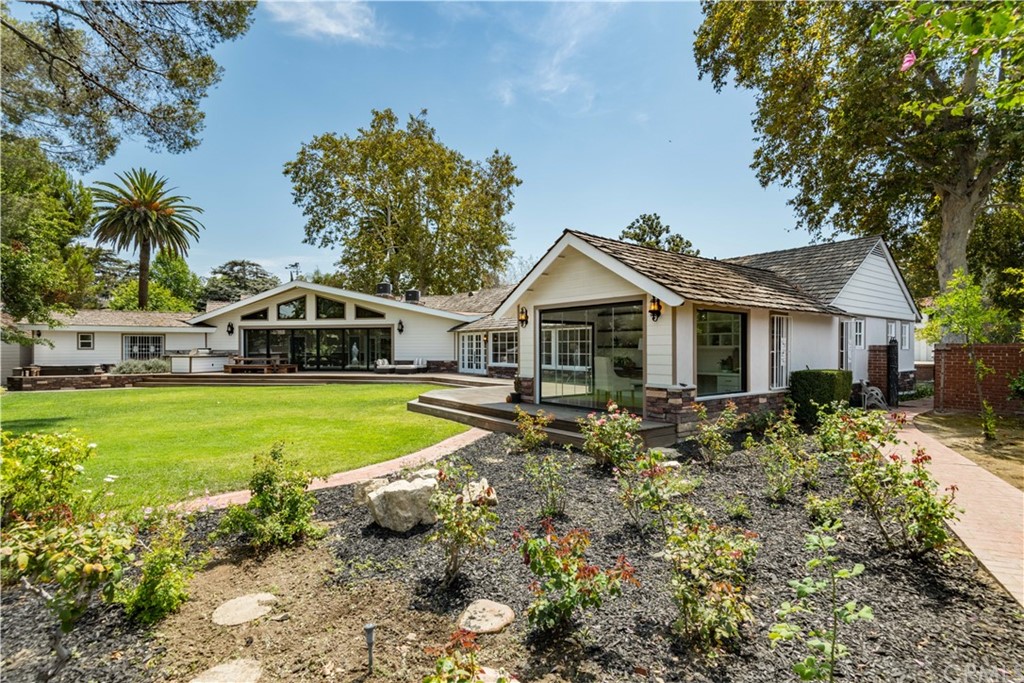4255 Chestnut Avenue Long Beach, CA 90807 - Photo 38 of 48 a view of house with garden and tall trees
