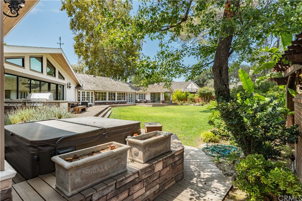 4255 Chestnut Avenue Long Beach, CA 90807 - Photo 39 of 48 a view of a patio with table and chairs potted plants and large tree