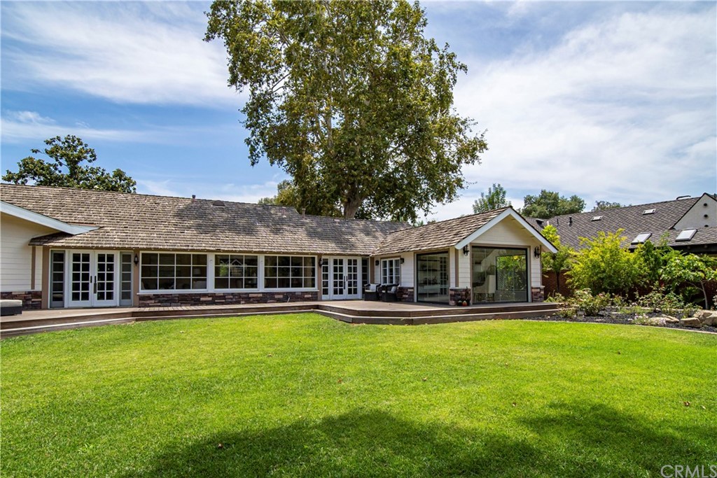 4255 Chestnut Avenue Long Beach, CA 90807 - Photo 43 of 48 a front view of a house with a yard table and chairs