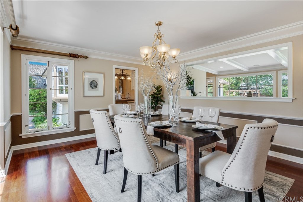 4255 Chestnut Avenue Long Beach, CA 90807 - Photo 8 of 48 a view of a dining room with furniture a chandelier and wooden floor