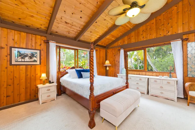 a bedroom with furniture and large window