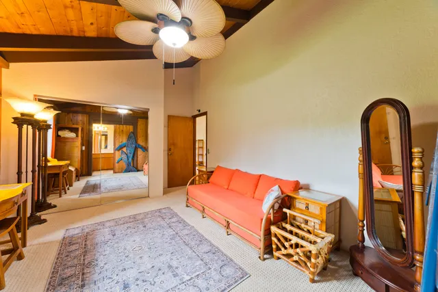 a living room with furniture fireplace and chandelier
