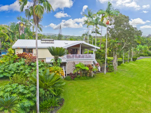 a view of a house with a big yard and garden