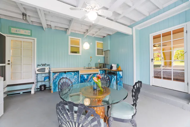 a view of a dining room with furniture and a window